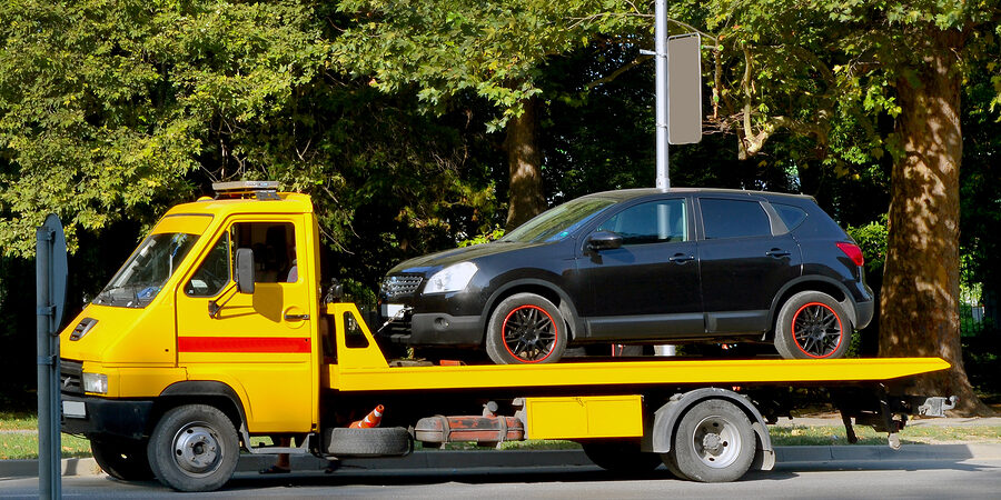 black car in the towing truck