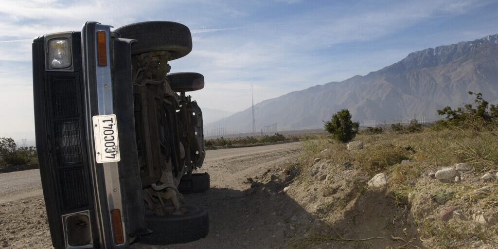 flipped car near the road